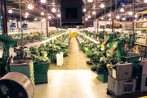 Rows of cold-heading machines on the AFI Industries factory floor